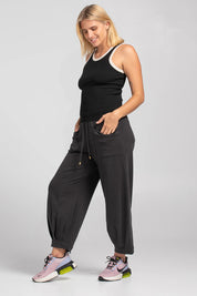 A model wearing the Guru Cotton Blend Track in colour Black (Black), from the front, showing the whole outfit
