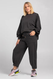 A model wearing the Guru Cotton Blend Track in colour Black (Black), from the front, showing the whole outfit