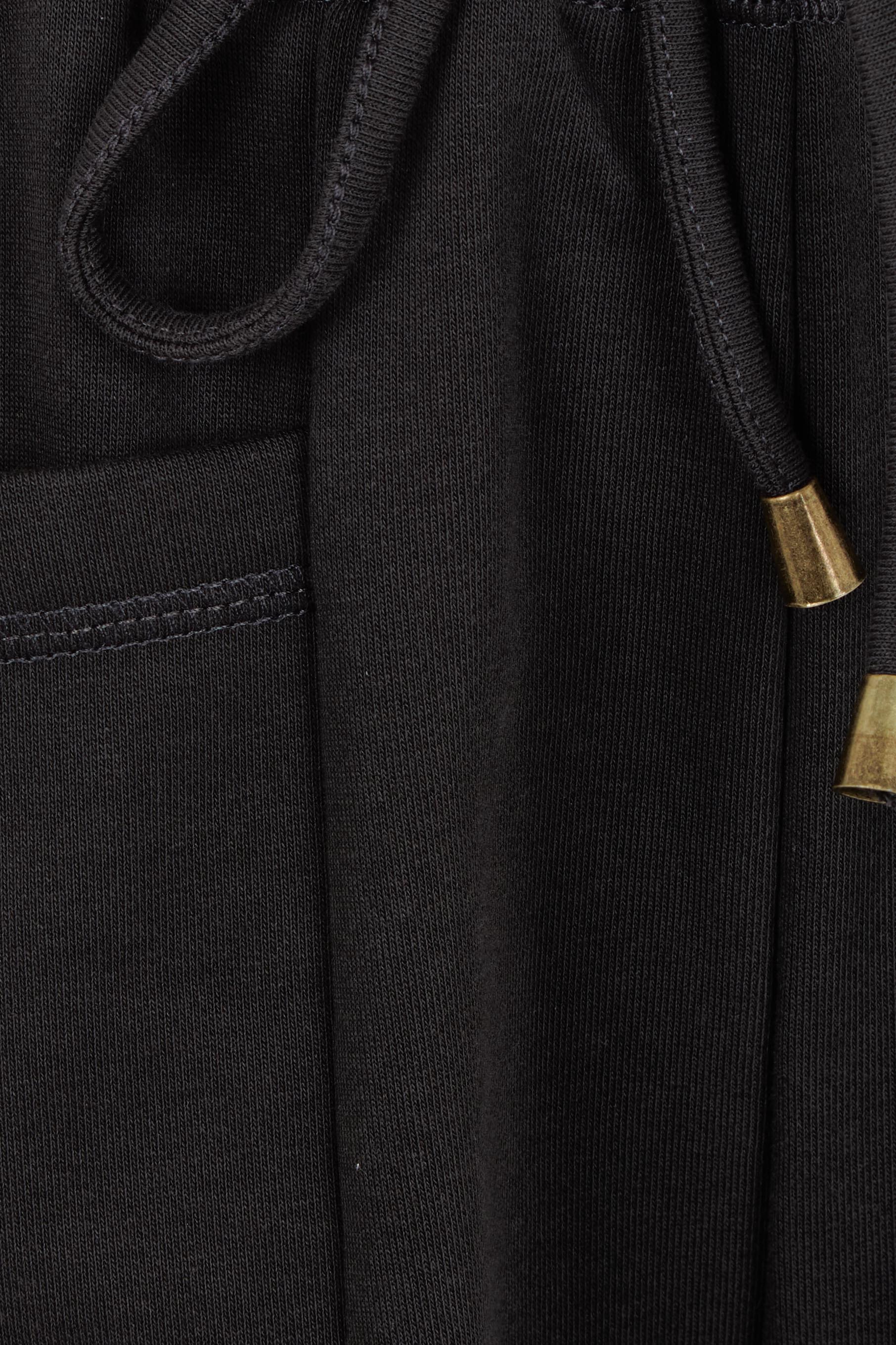 Product shot of the Guru Cotton Blend Track in colour Black (Black), detail