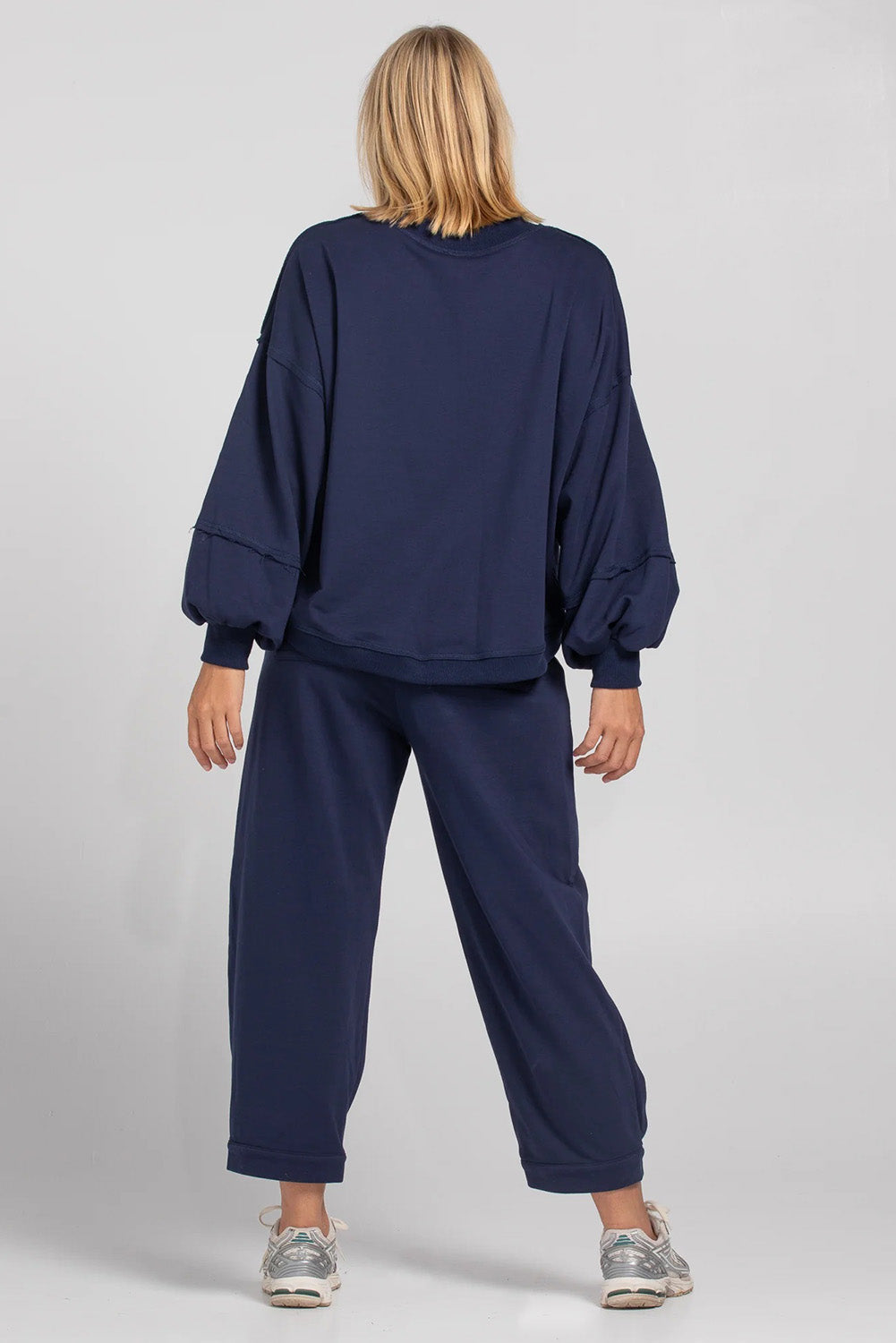 A model wearing the Guru Cotton Blend Track in colour Navy (Blue), from the back