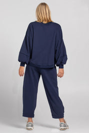 A model wearing the Guru Cotton Blend Track in colour Navy (Blue), from the back