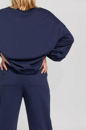 A model wearing the Guru Cotton Blend Track in colour Navy (Blue), from the back