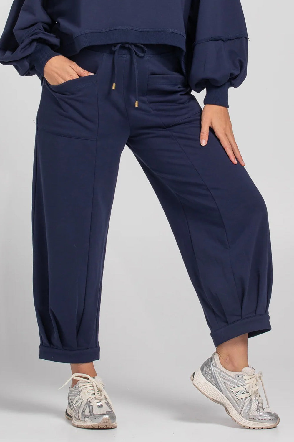 A model wearing the Guru Cotton Blend Track in colour Navy (Blue), from the front, cropped image