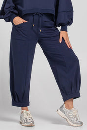 A model wearing the Guru Cotton Blend Track in colour Navy (Blue), from the front, cropped image