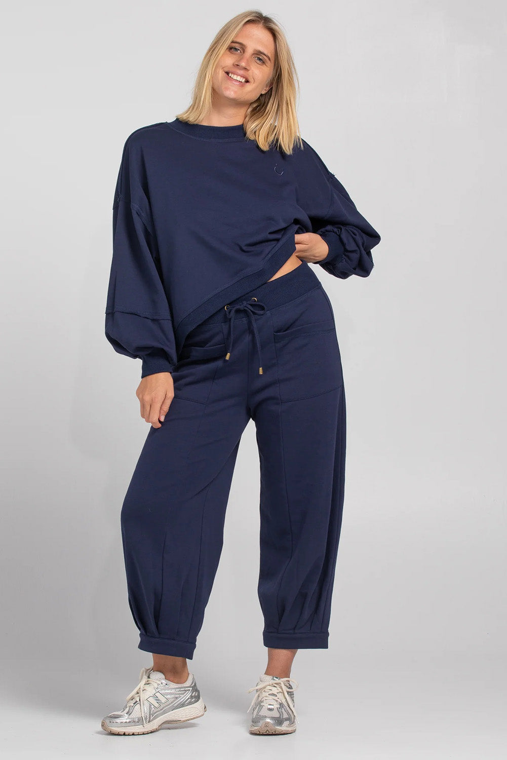 A model wearing the Guru Cotton Blend Track in colour Navy (Blue), from the front, showing the whole outfit