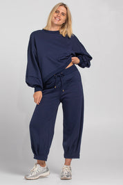 A model wearing the Guru Cotton Blend Track in colour Navy (Blue), from the front, showing the whole outfit