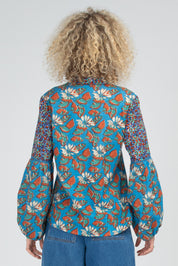 A model wearing the Mittie Cotton Top in colour Lettie (Blue), from the back