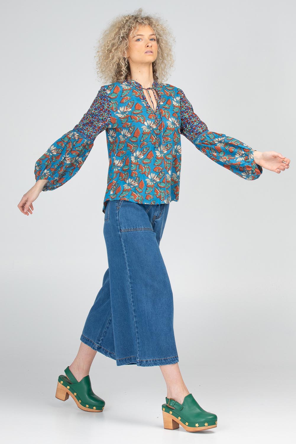 A model wearing the Mittie Cotton Top in colour Lettie (Blue), from the front, showing the whole outfit