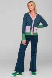 A model wearing the Poet Cardigan in colour Bluemulti (Blue), from the front, showing the whole outfit