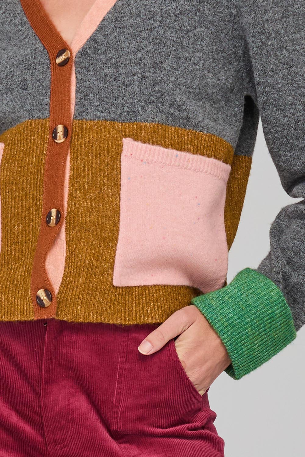 A model wearing the Remi Cardigan in colour Grey (Grey), from the front, cropped image