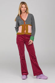 A model wearing the Dharma Pant in colour Cranberry (Red), from the front, showing the whole outfit