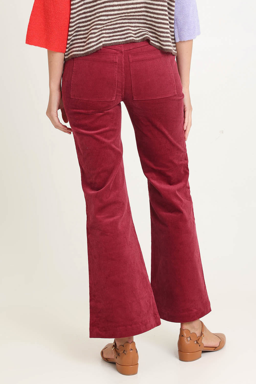 Model Madeline wearing size 10 of the Dharma Pant in colour Cranberry (Red), from the back