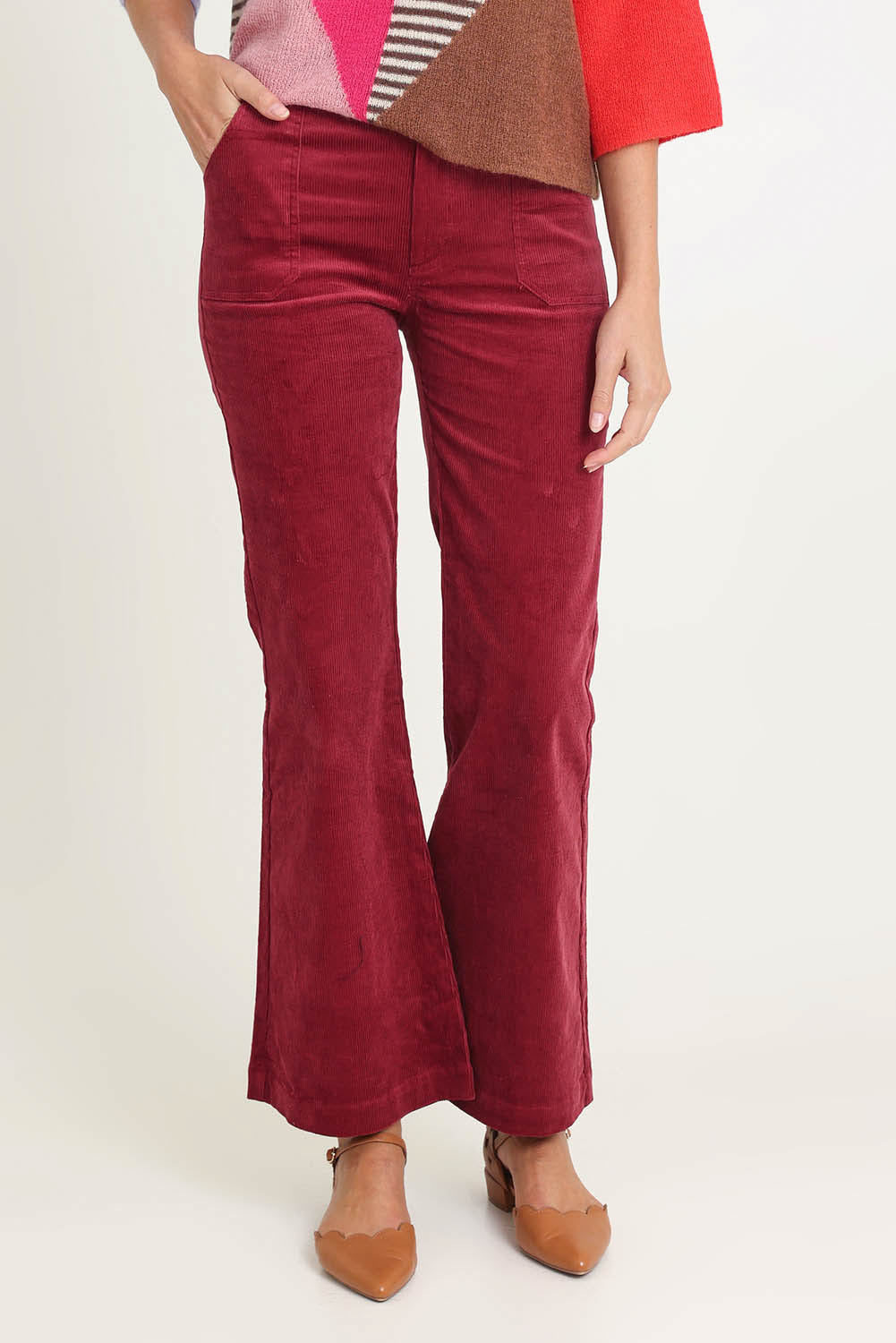 Model Madeline wearing size 10 of the Dharma Pant in colour Cranberry (Red), from the front, cropped image
