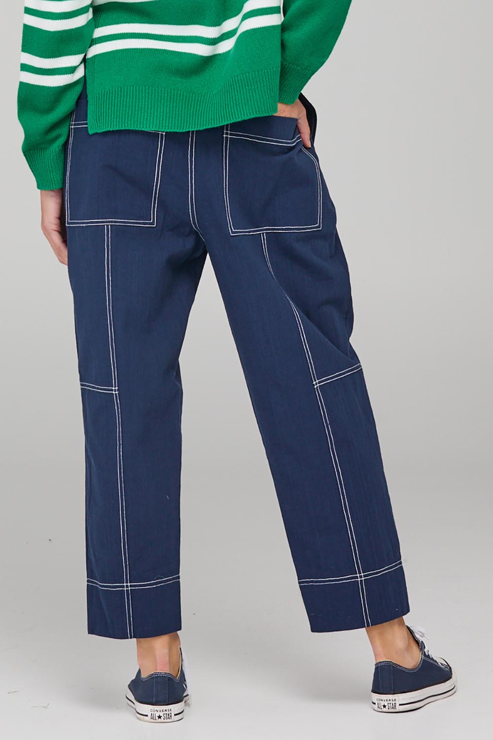 A model wearing the Jonte Pant in colour Navy (Blue), from the back