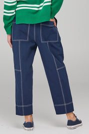 A model wearing the Jonte Pant in colour Navy (Blue), from the back