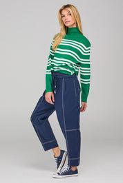 A model wearing the Jonte Pant in colour Navy (Blue), from the front, showing the whole outfit