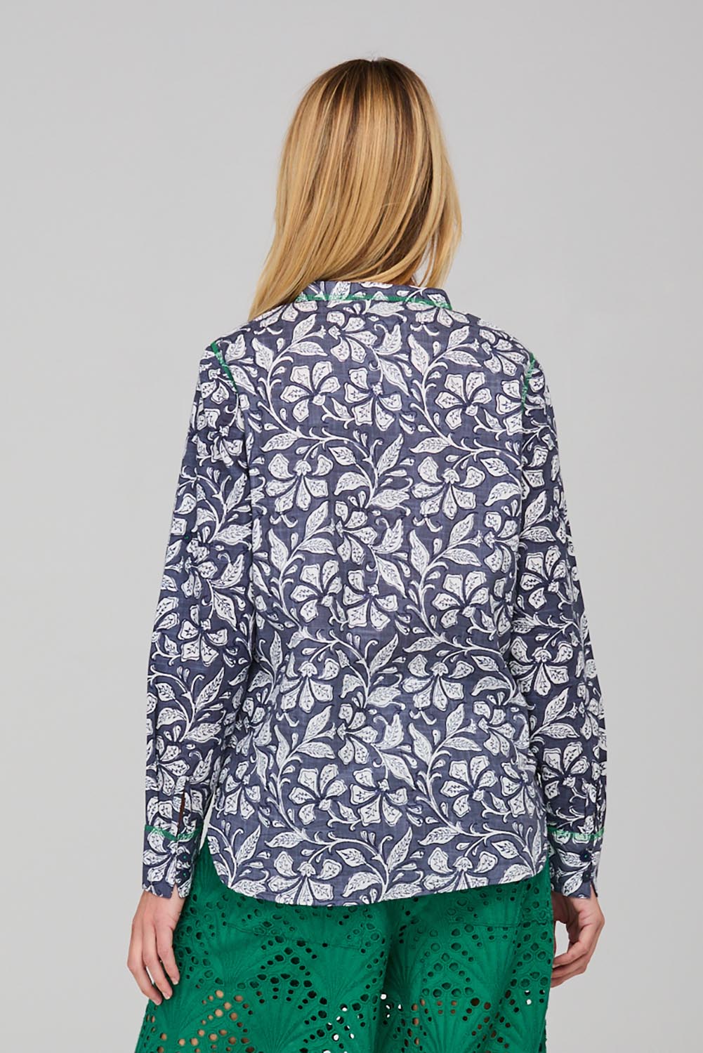 A model wearing the Clove Shirt in colour Izuminavy (Blue), from the back