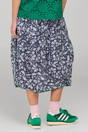 A model wearing the Guru Skirt in colour Izuminavy (Blue), from the back
