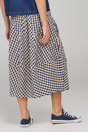 A model wearing the Guru Skirt in colour Navyseer (Blue), from the back