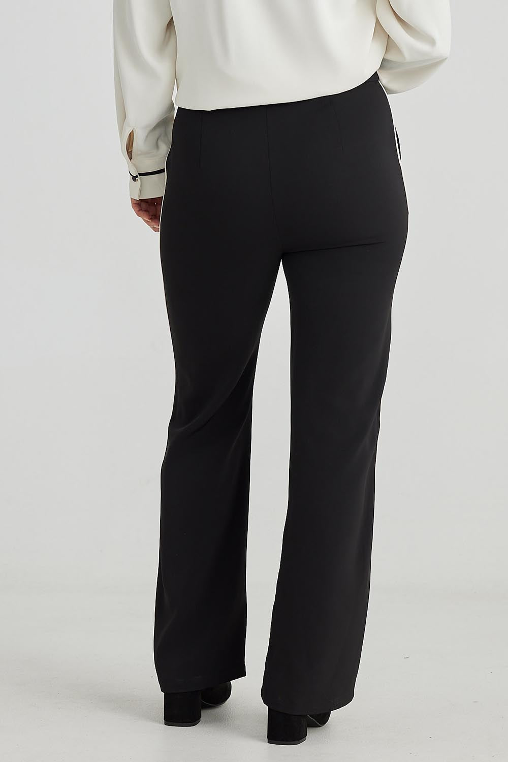 A model wearing the Blake Pant in colour Black (Black), from the back