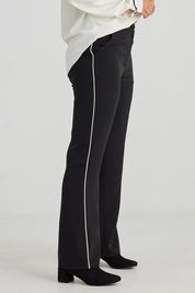 A model wearing the Blake Pant in colour Black (Black), from the front, cropped image