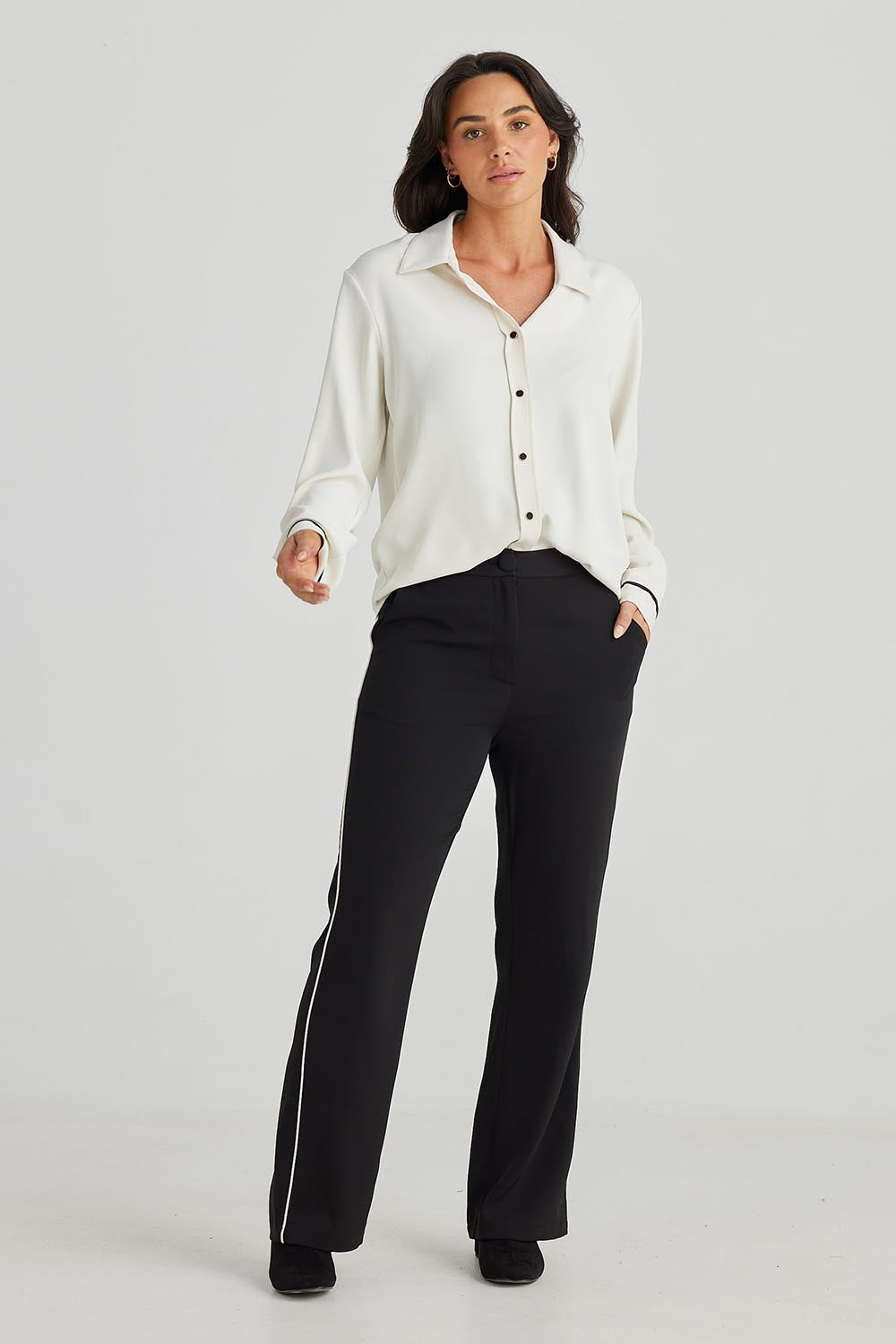 A model wearing the Blake Pant in colour Black (Black), from the front, showing the whole outfit