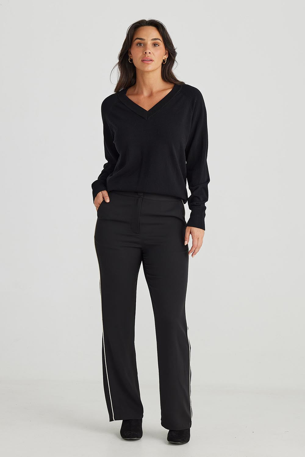 A model wearing the Blake Pant in colour Black (Black), from the front, showing the whole outfit