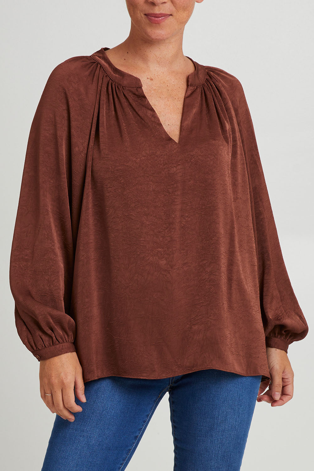 Model Katie wearing size S of the Diego Top in colour Cocoa, from the front, cropped image