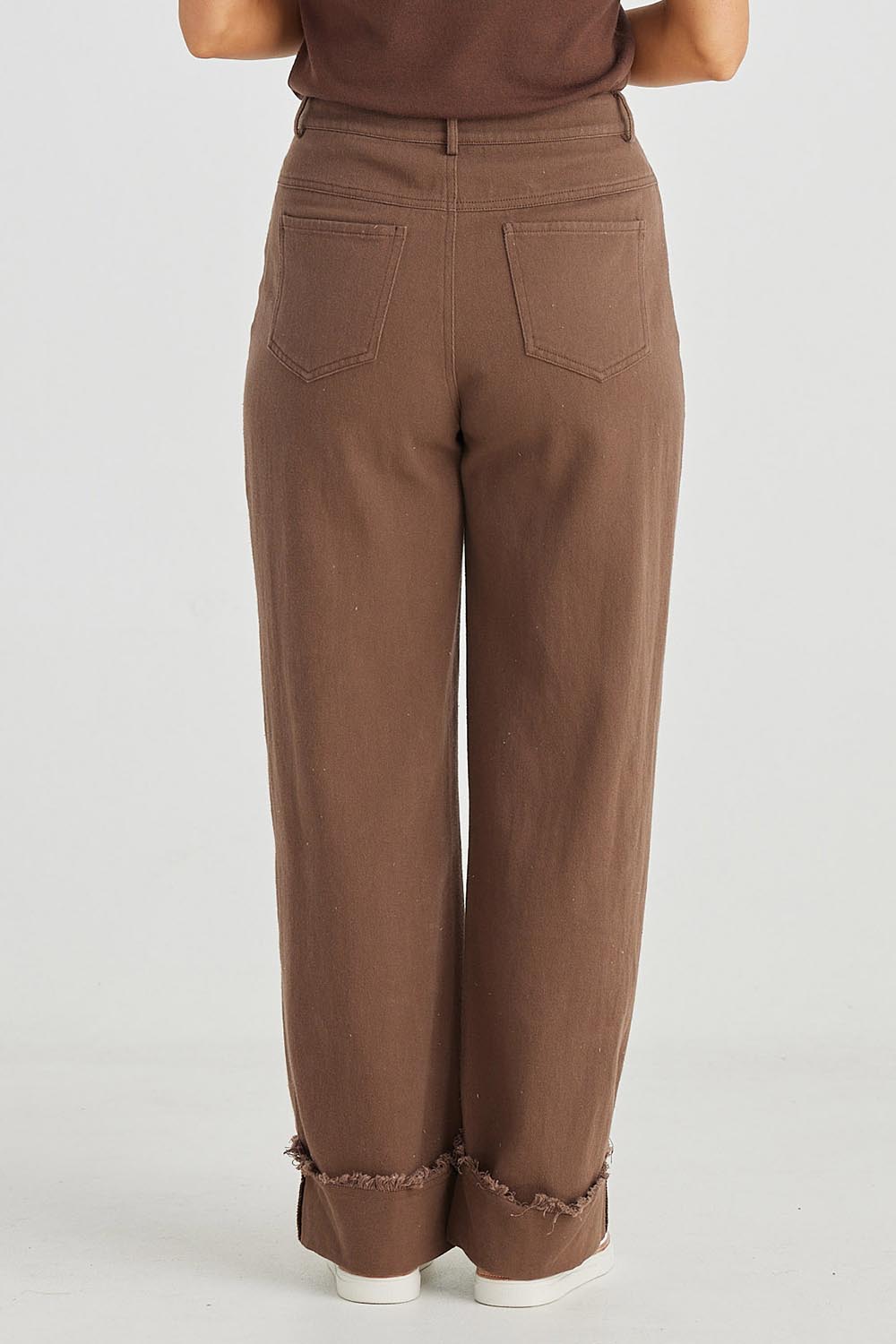 A model wearing the Leroy Pant in colour Chocolate, from the back