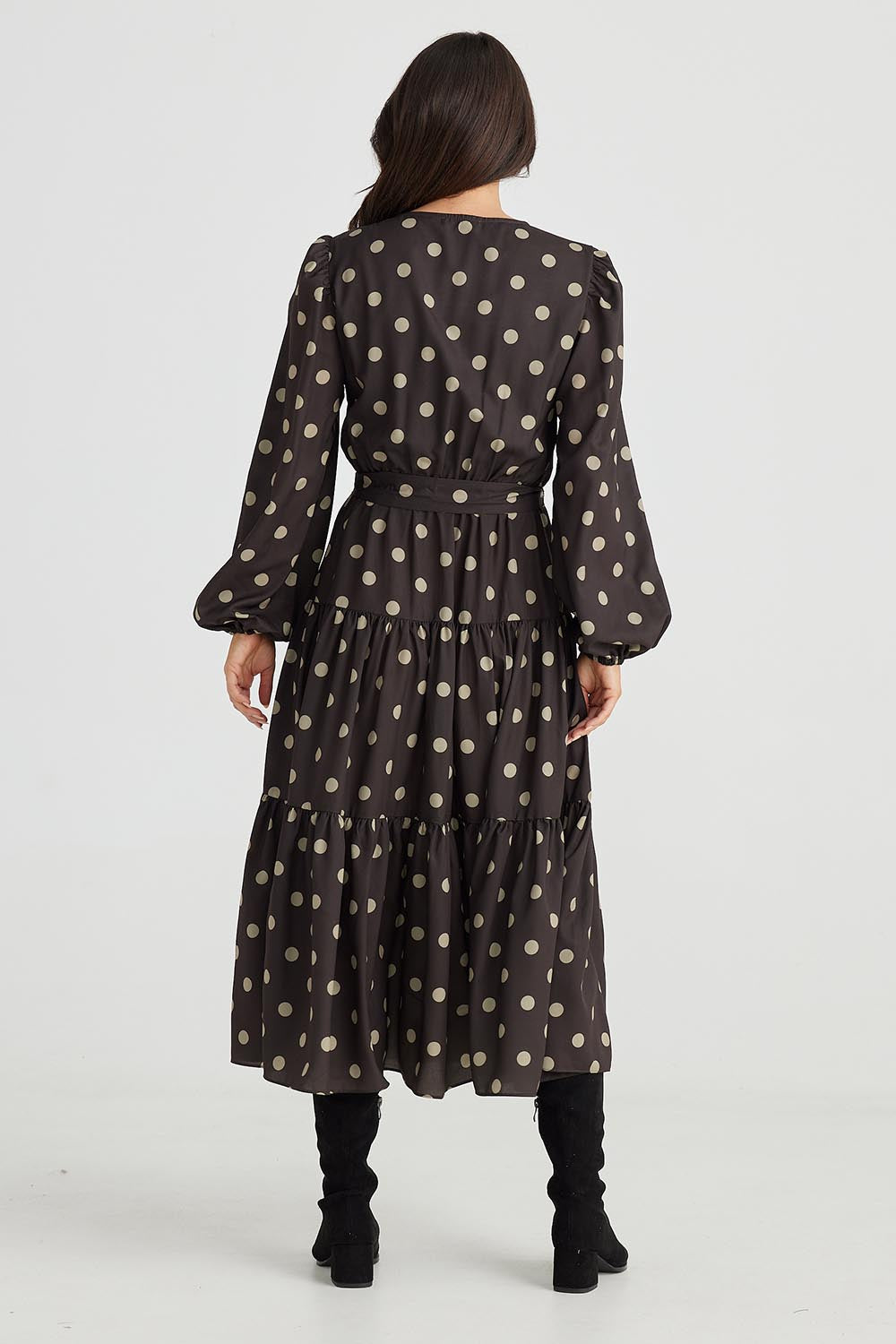 A model wearing the Zion Dress in colour Stonespot (Black), from the back