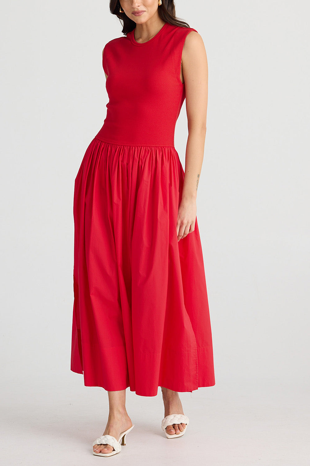 A model wearing the Daphne Cotton Blend Dress in colour Chilli (Red), from the front, cropped image