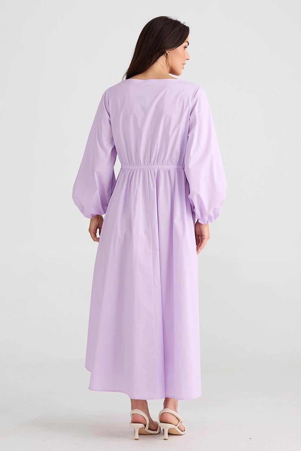 A model wearing the Daylight Cotton Dress in colour Lilac (Purple), from the back