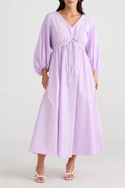 A model wearing the Daylight Cotton Dress in colour Lilac (Purple), from the front, cropped image