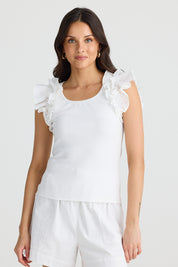 A model wearing the Frills Tank in colour White (White), from the front, cropped image