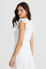 A model wearing the Frills Tank in colour White (White), from the front, cropped image