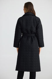A model wearing the Bedford Longline Puffer in colour Black (Black), from the back