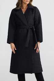 A model wearing the Bedford Longline Puffer in colour Black (Black), from the front, cropped image