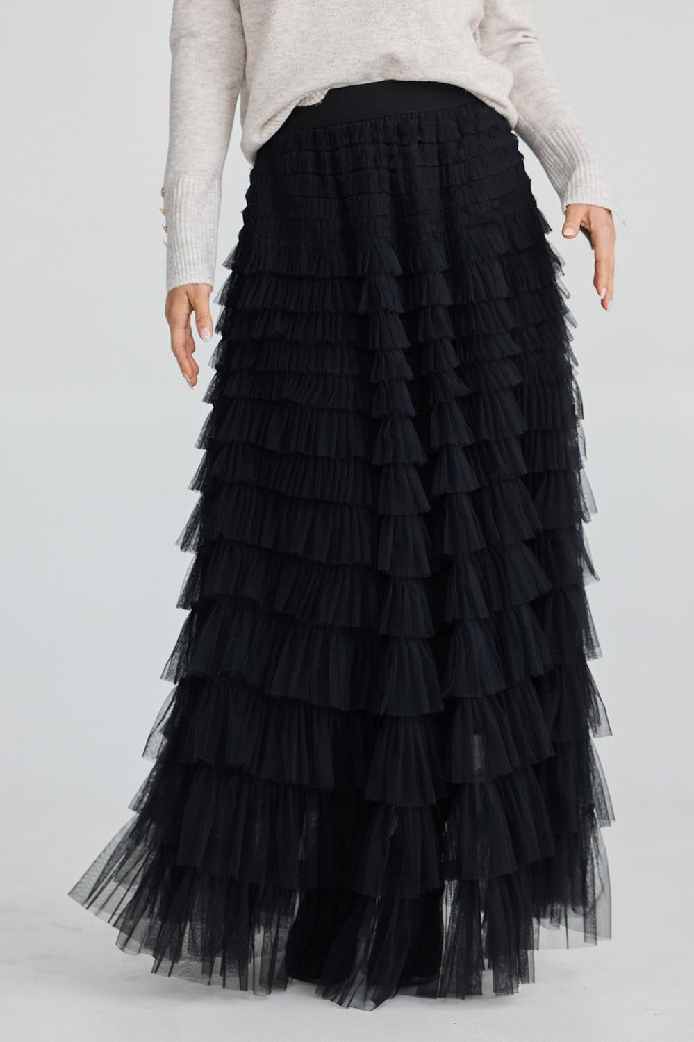 A model wearing the Chance Skirt in colour Black (Black), from the front, cropped image