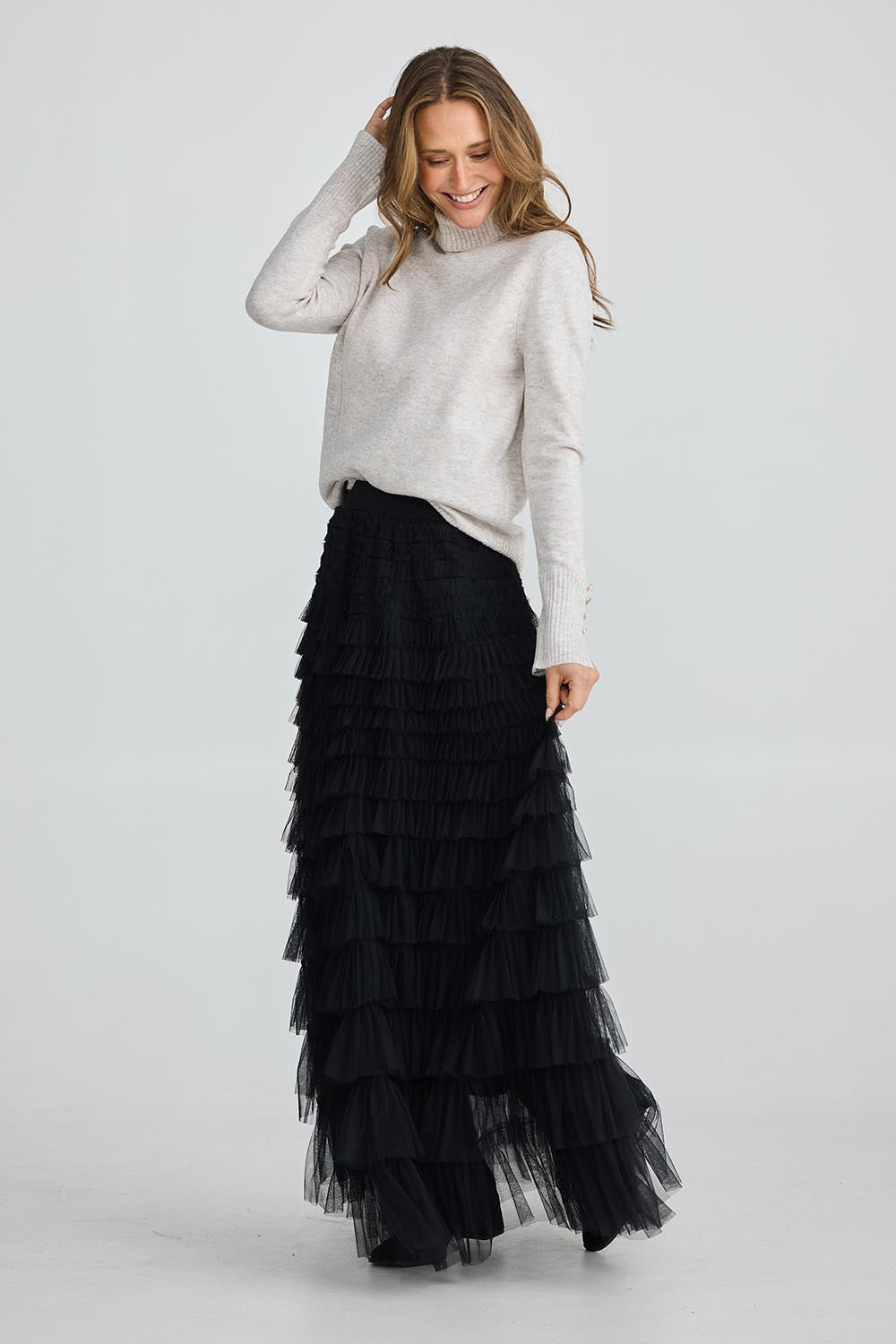 A model wearing the Chance Skirt in colour Black (Black), from the front, showing the whole outfit