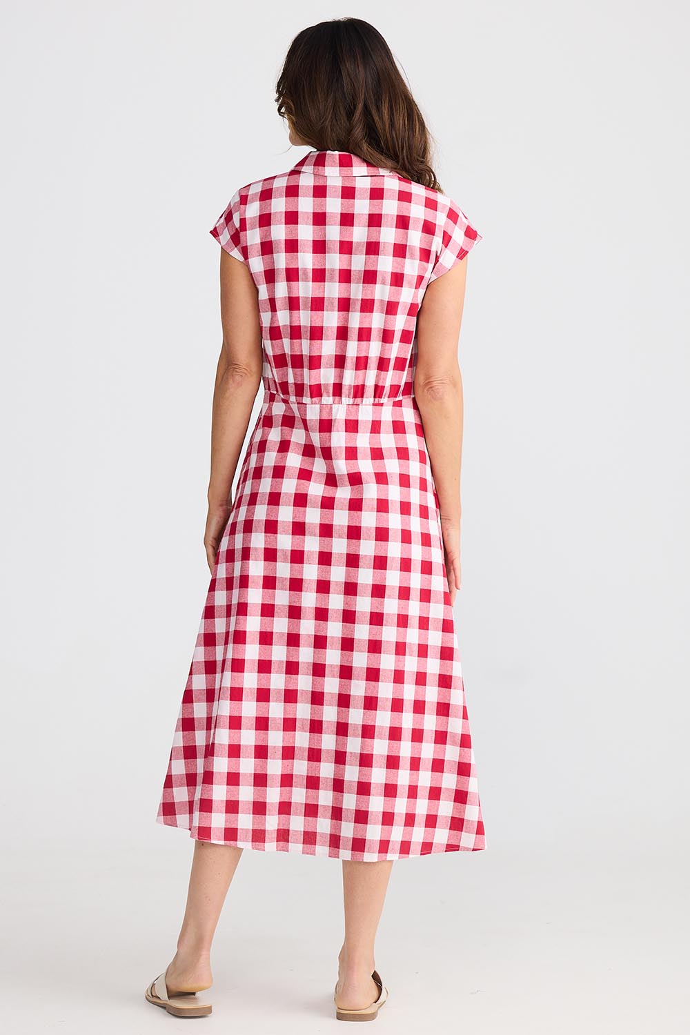 A model wearing the Musings Cotton Dress in colour Redgingham (Red), from the back