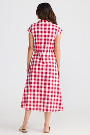 A model wearing the Musings Cotton Dress in colour Redgingham (Red), from the back