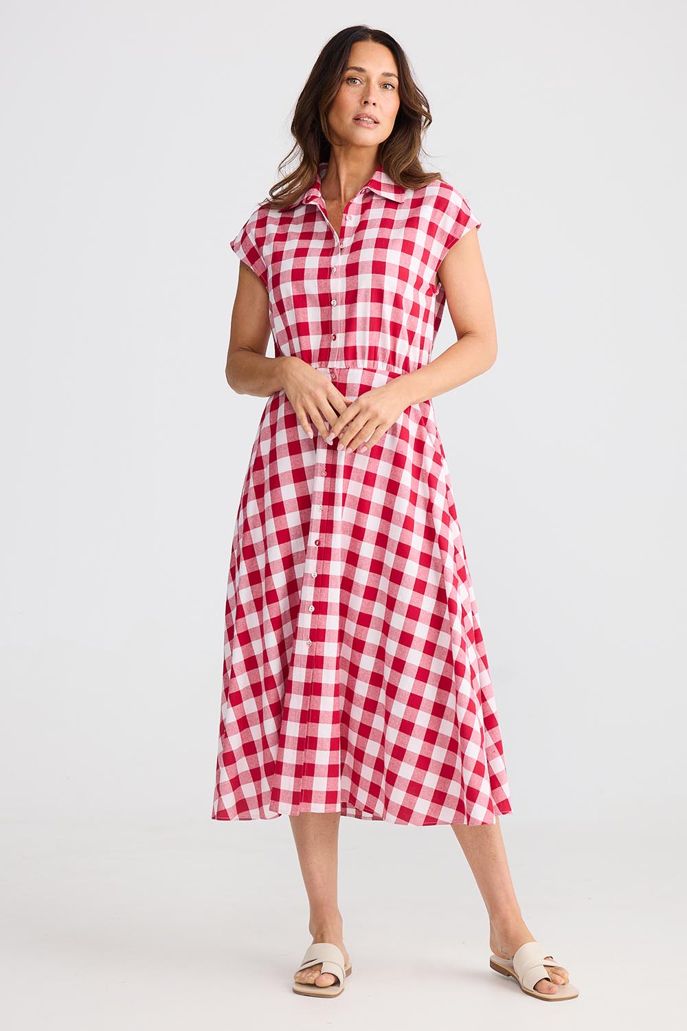 A model wearing the Musings Cotton Dress in colour Redgingham (Red), from the front, showing the whole outfit