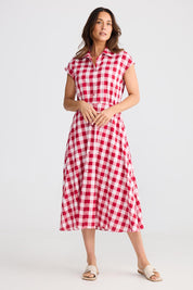 A model wearing the Musings Cotton Dress in colour Redgingham (Red), from the front, showing the whole outfit
