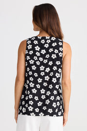 A model wearing the Veronica Top in colour Distydaisy (Black), from the back