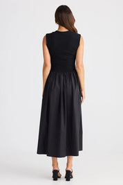 A model wearing the Daphne Cotton Dress in colour Black (Black), from the back