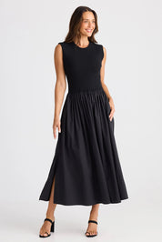 A model wearing the Daphne Cotton Dress in colour Black (Black), from the front, showing the whole outfit