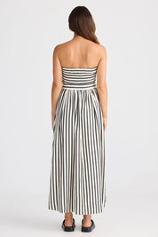 A model wearing the Avalon Dress in colour Blackstrip, from the back