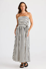 A model wearing the Avalon Dress in colour Blackstrip, from the front, showing the whole outfit