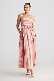 A model wearing the Avalon Dress in colour Painterly, from the front, showing the whole outfit
