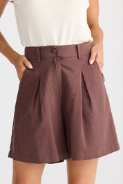 A model wearing the Eden Cotton Linen Blend Short in colour Chocolate, from the front, cropped image